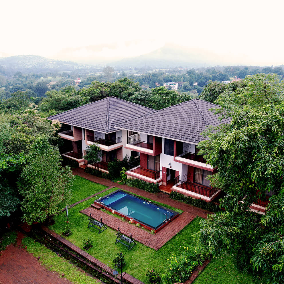 Resort with a pool surrounded by trees