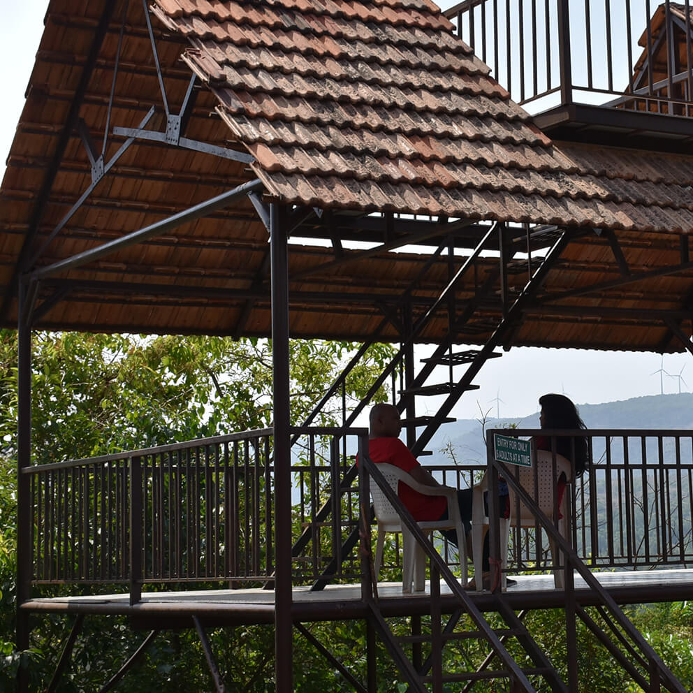 Couple sits together on a balcony enjoying the view