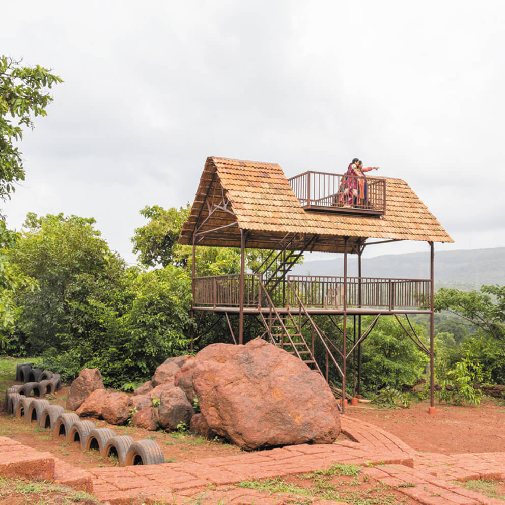 Couple sitting together on a wooden structure enjoying the view